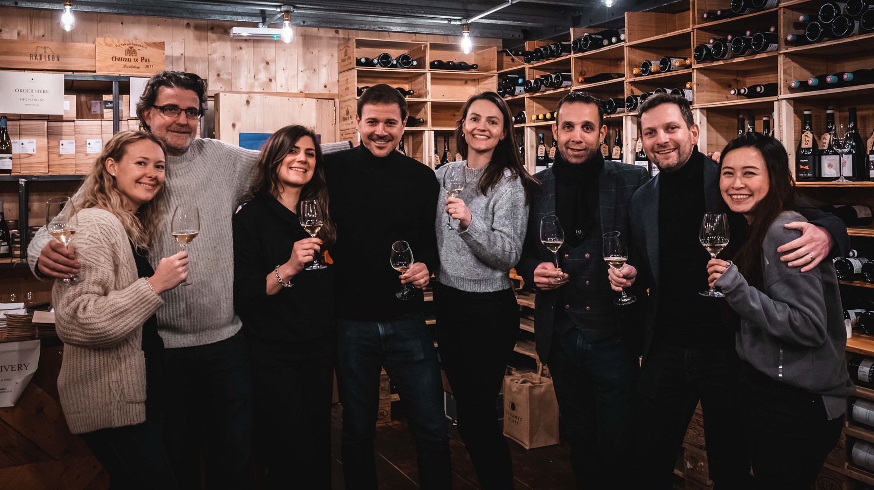 Dynamic wines team holding wine glasses